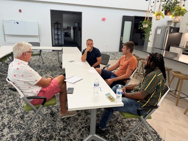 A mentor meeting with a small group of emerging leaders for a Spiritual Board of Advisors session